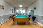 Pool table in the game room with a ping pong table top to use as well.  Patio doors walk out onto the covered patio with the hot tub